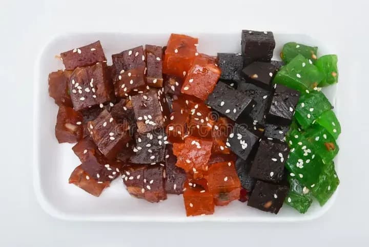Pieces of black, red and green halwa